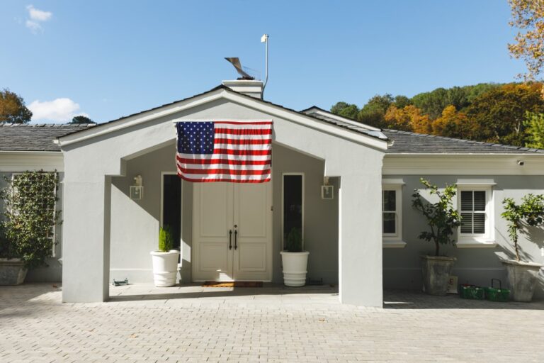 House decorated with american flag with landscape and blue sky with clouds in background. prepared for soldier returning home to family.