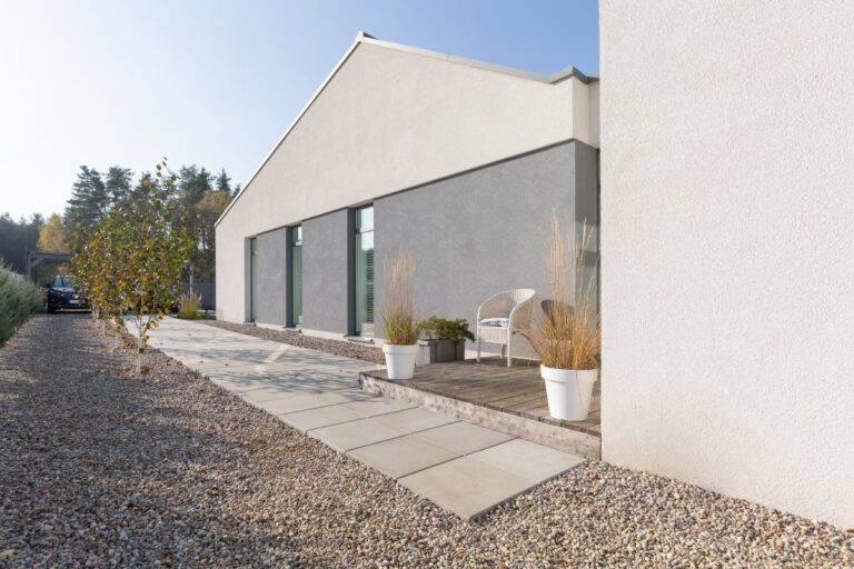 Green and grey backyard of modern suburban house