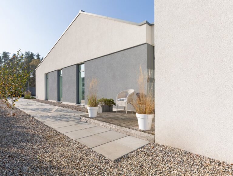 Green and grey backyard of modern suburban house