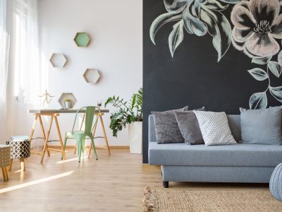 Spacious room with grey sofa and blackboard wall