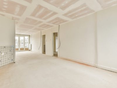 Empty room with windows and radiator in daylight
