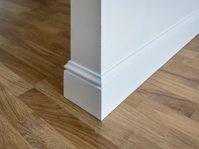 Detail of corner flooring with intricate crown molding and plinth.